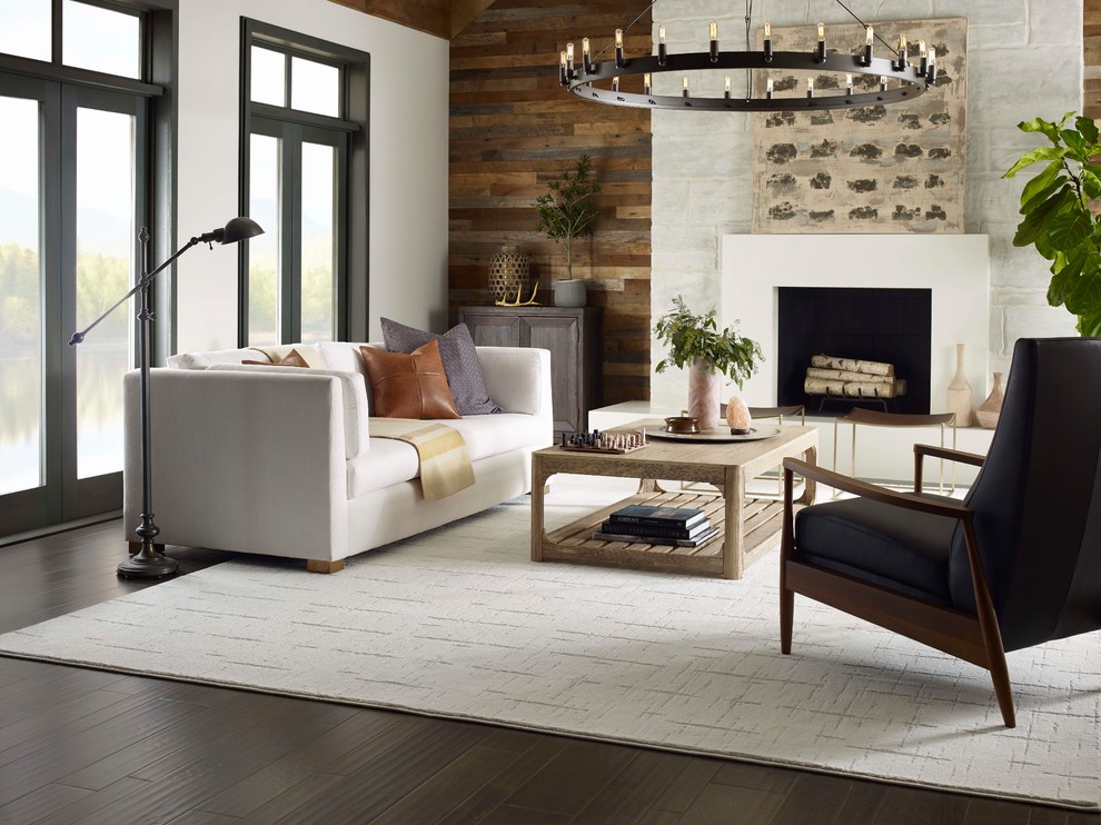 Design ideas for a medium sized rustic formal enclosed living room in New York with white walls, painted wood flooring, a standard fireplace, a plastered fireplace surround, no tv and brown floors.