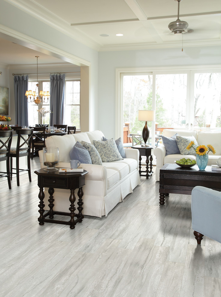 Living room - mid-sized coastal formal and open concept light wood floor and gray floor living room idea in Orange County with blue walls, no fireplace and no tv