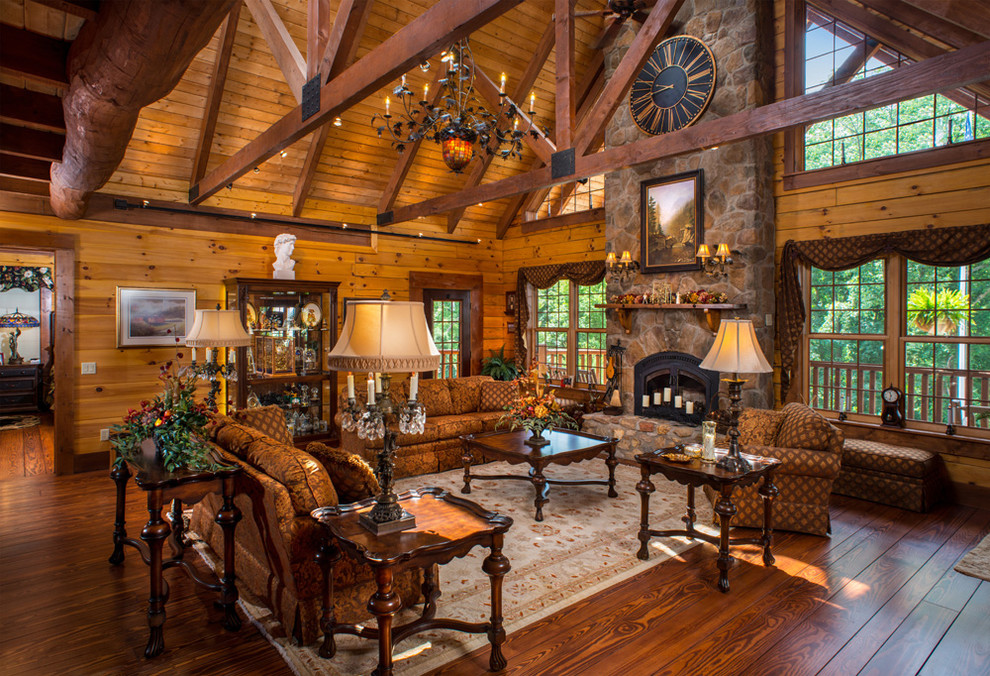 This is an example of a large rustic formal open plan living room in Columbus with brown walls, dark hardwood flooring, no tv and feature lighting.