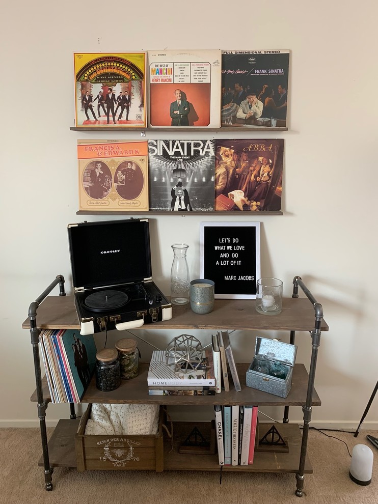 This is an example of an urban living room in Chicago with a music area, white walls, carpet and beige floors.