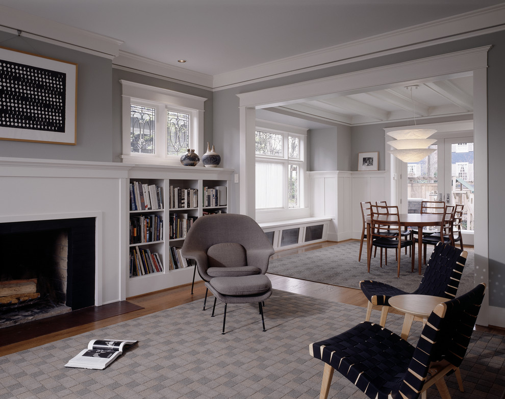 Mid-sized elegant formal medium tone wood floor living room photo in Seattle with gray walls, a standard fireplace and no tv