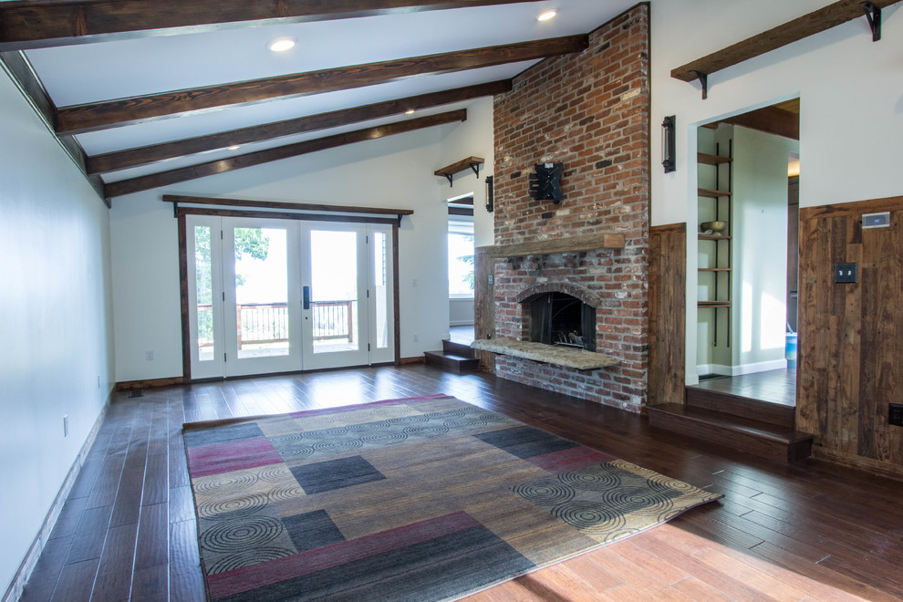 Design ideas for a medium sized rustic living room in Portland with a standard fireplace and a brick fireplace surround.