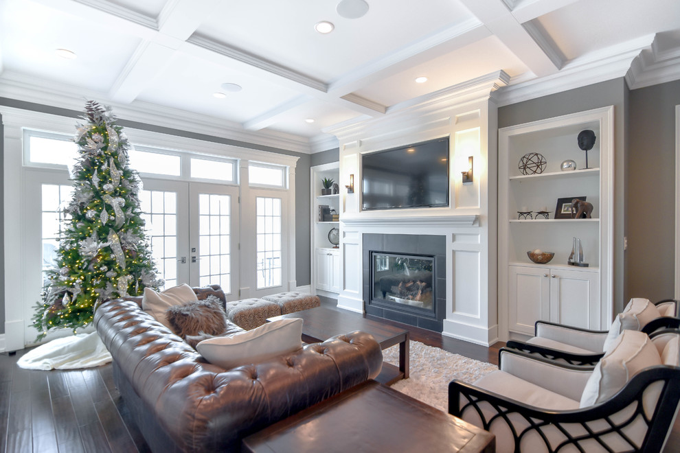 Large transitional formal and open concept vinyl floor and brown floor living room photo in Edmonton with gray walls, a standard fireplace, a plaster fireplace and a media wall