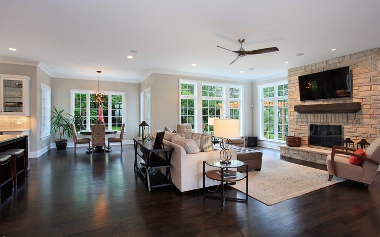 This is an example of an expansive victorian open plan living room in Chicago with beige walls, dark hardwood flooring, a standard fireplace, a stone fireplace surround and a wall mounted tv.