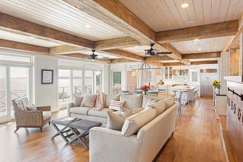 casual family room with light wood floor and recycled barn beams
