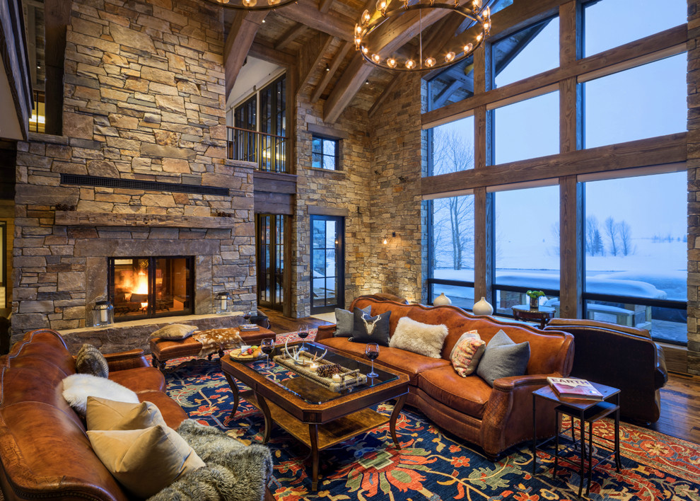 This is an example of a rustic living room in Other with dark hardwood flooring, a standard fireplace, a stone fireplace surround and no tv.
