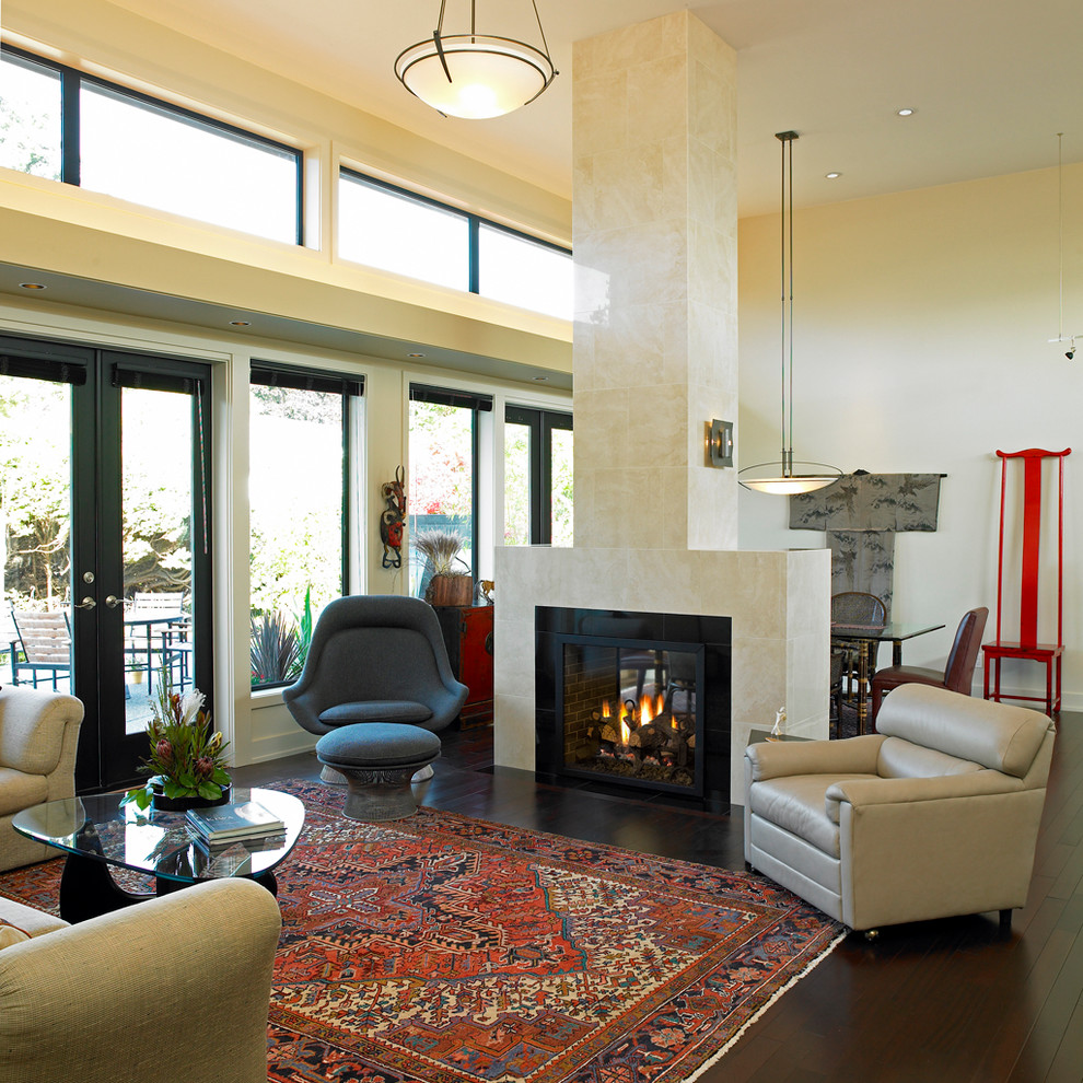 Contemporary living room in Vancouver with beige walls and a two-sided fireplace.