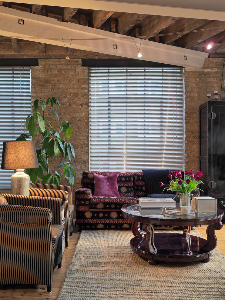 This is an example of a medium sized eclectic open plan living room in London with multi-coloured walls, medium hardwood flooring and a freestanding tv.