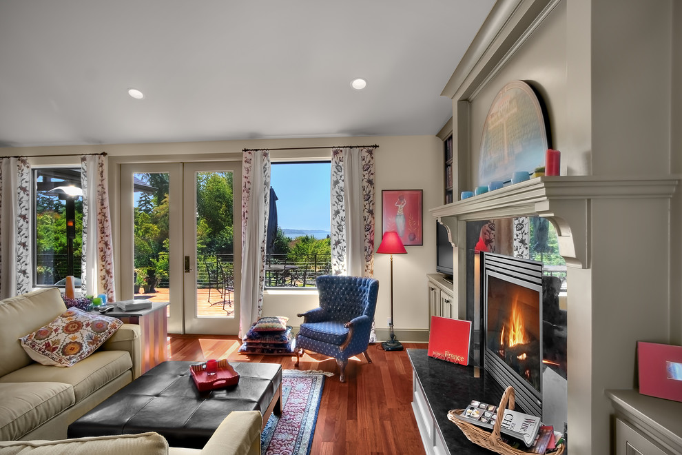 Elegant living room photo in Seattle with a standard fireplace and a tv stand