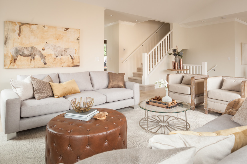 Example of a transitional open concept living room design in Vancouver with beige walls
