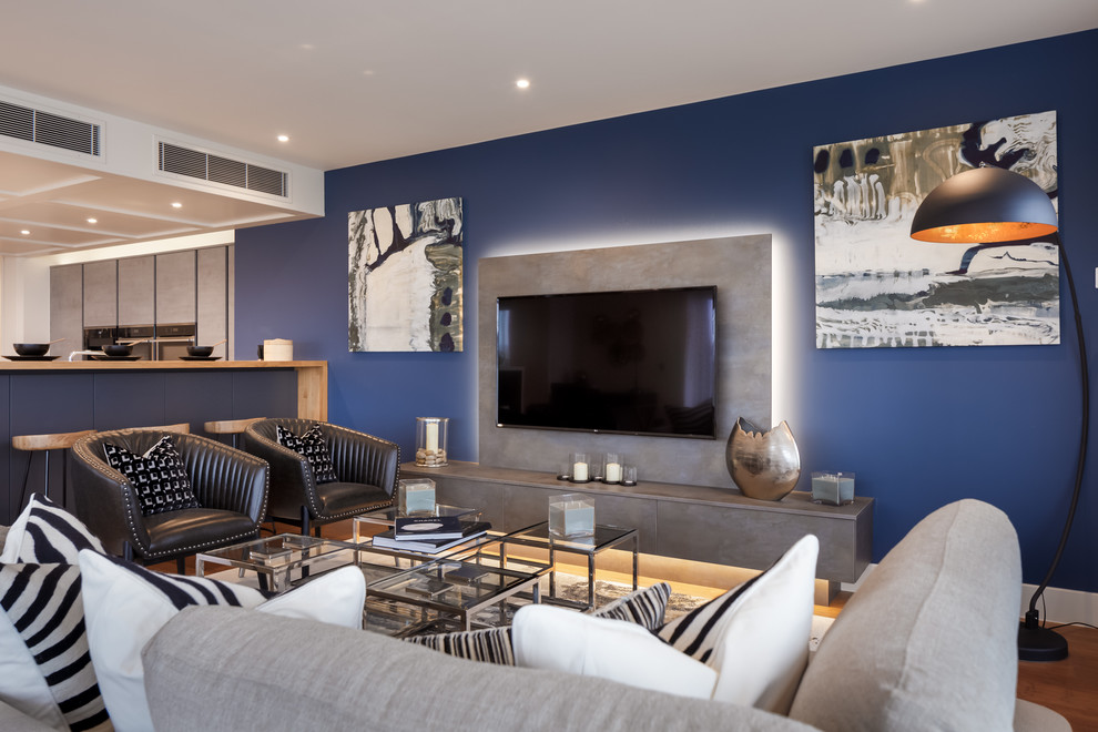 Design ideas for a contemporary living room in Dorset with blue walls and a wall mounted tv.
