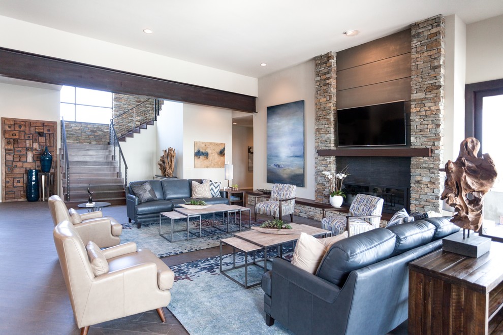 This is an example of a modern open plan living room in Sacramento with grey walls, porcelain flooring, a standard fireplace, a stone fireplace surround and a wall mounted tv.