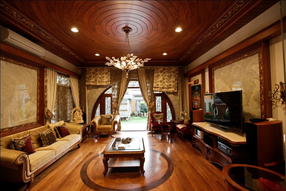 Example of a mid-sized asian formal and enclosed medium tone wood floor living room design in Bengaluru with a tv stand