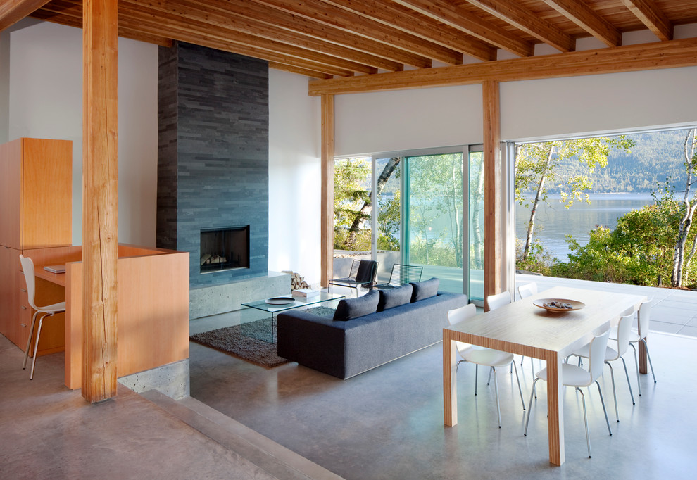 Design ideas for a modern living room in Vancouver with concrete flooring.