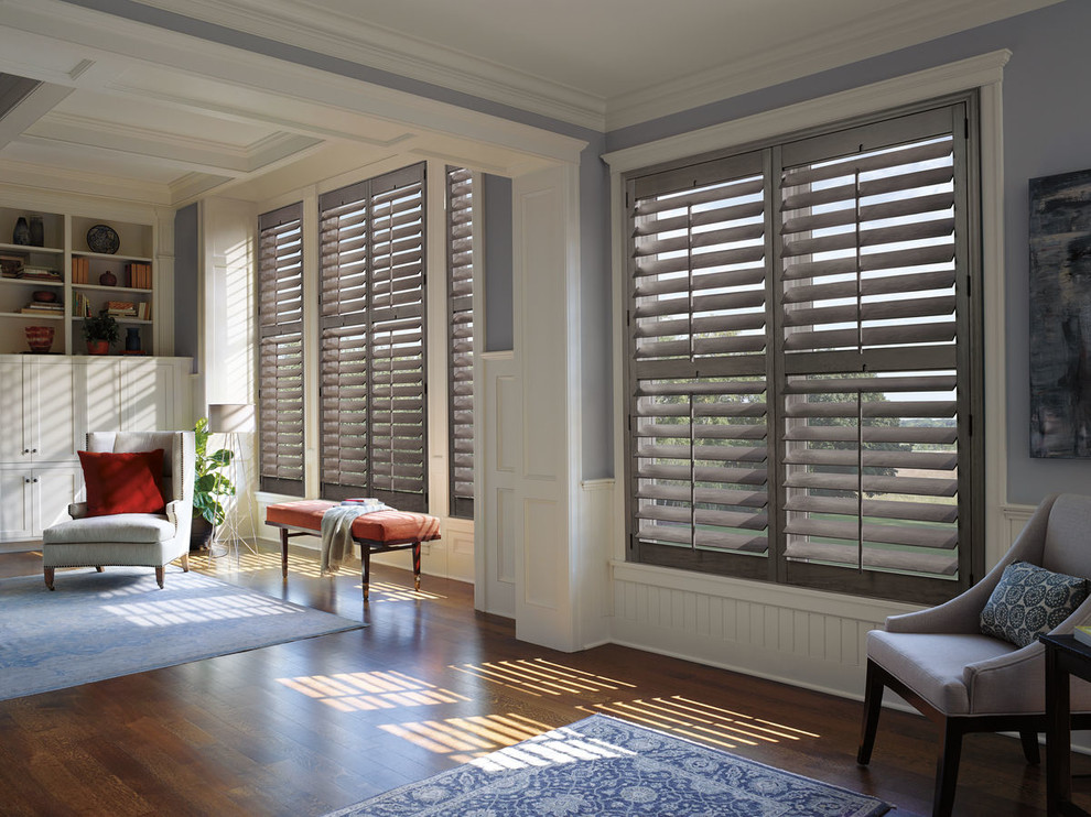 Photo of a large nautical enclosed living room in New York with grey walls, medium hardwood flooring, no fireplace, no tv and brown floors.