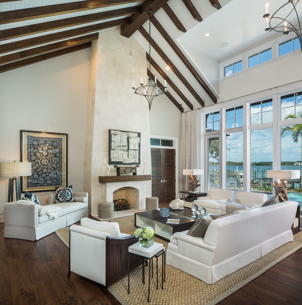 Inspiration for a huge contemporary open concept and formal dark wood floor living room remodel in Tampa with beige walls, a standard fireplace, a stone fireplace and no tv