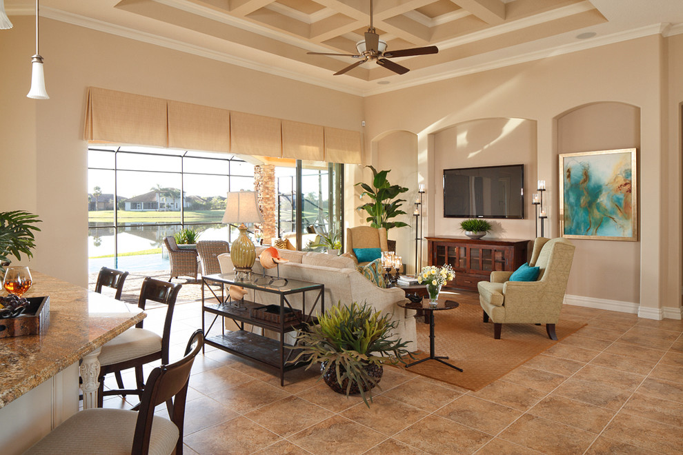 Design ideas for a medium sized world-inspired open plan living room in Orlando with beige walls, limestone flooring, a wall mounted tv, beige floors and feature lighting.