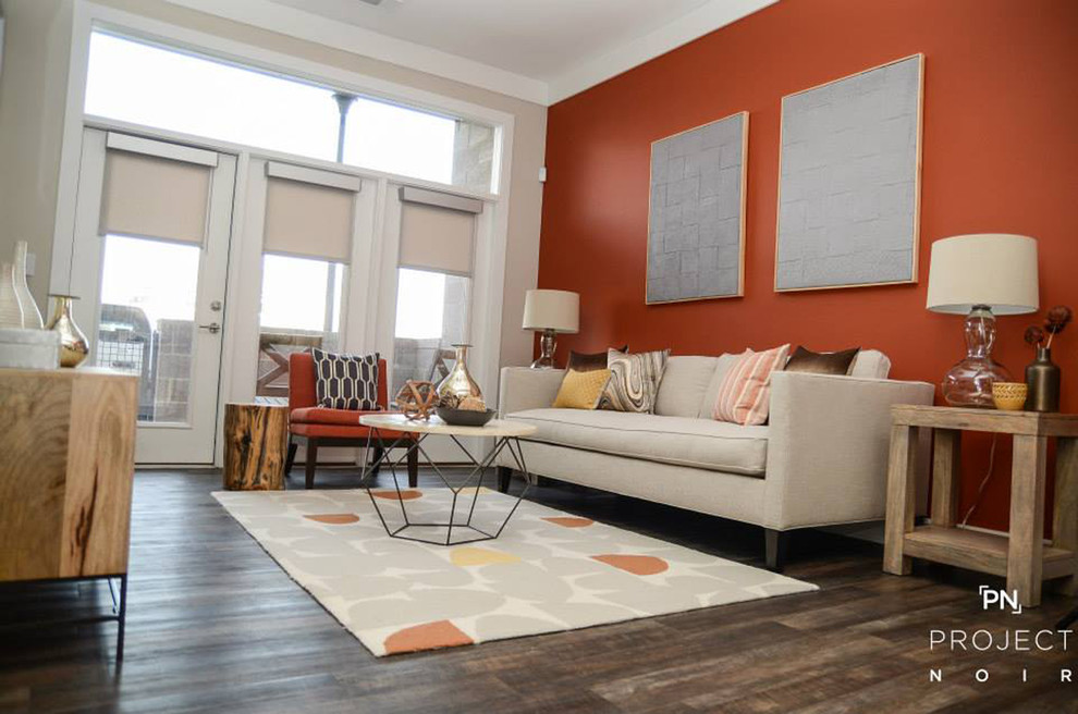 This is an example of a small contemporary enclosed living room in Charlotte with orange walls and medium hardwood flooring.