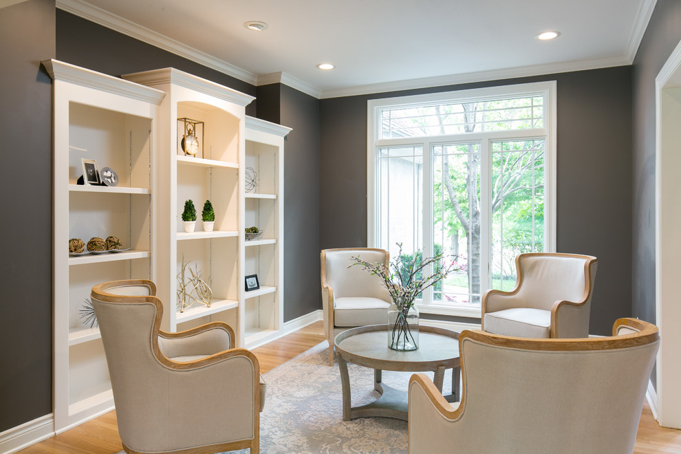 Elegant enclosed light wood floor living room photo in Kansas City with gray walls