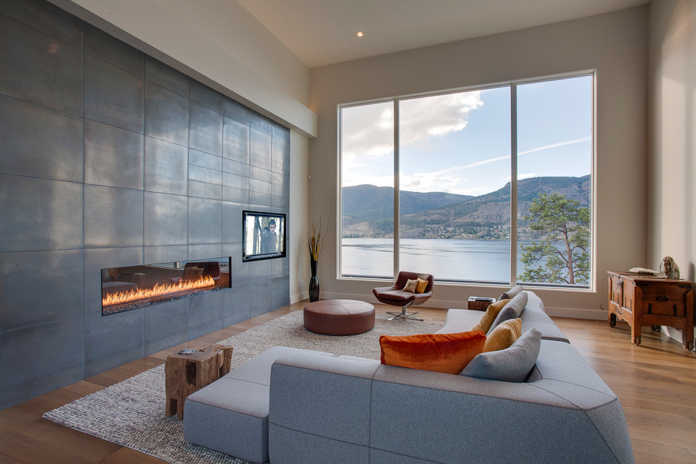Photo of a contemporary living room in Vancouver with a ribbon fireplace and a built-in media unit.