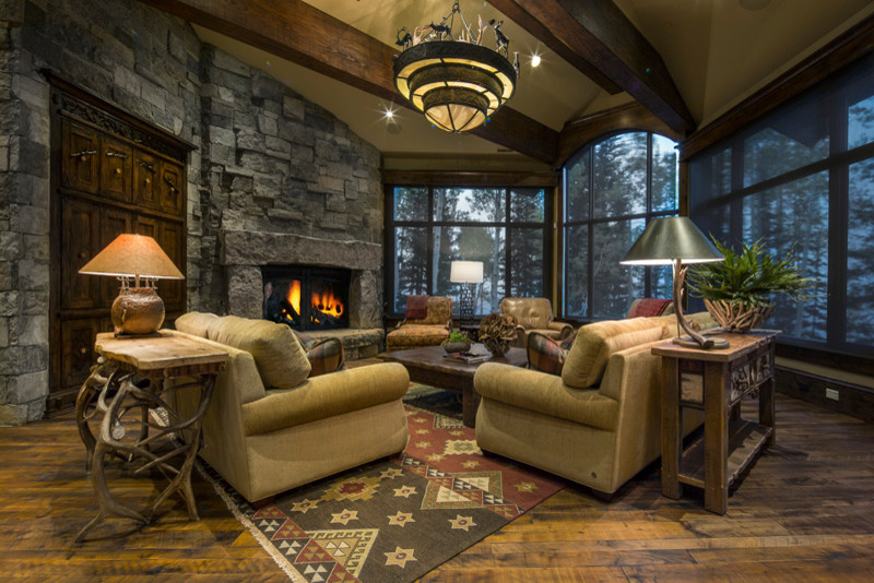 Living room - large rustic open concept and formal medium tone wood floor living room idea in Salt Lake City with a standard fireplace, a stone fireplace and no tv