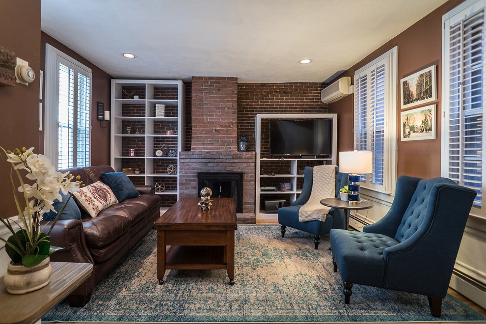 Living room - transitional medium tone wood floor and brown floor living room idea in Boston with brown walls, a standard fireplace, a brick fireplace and a wall-mounted tv