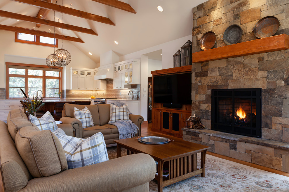 Inspiration for a mid-sized transitional open concept medium tone wood floor and brown floor living room remodel in Other with white walls, a standard fireplace, a stone fireplace and a media wall