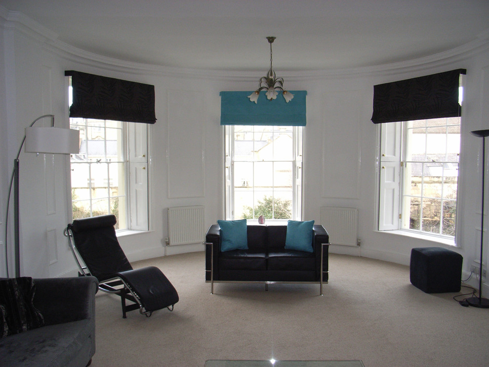 Example of a mid-sized trendy enclosed carpeted living room design in Other with white walls