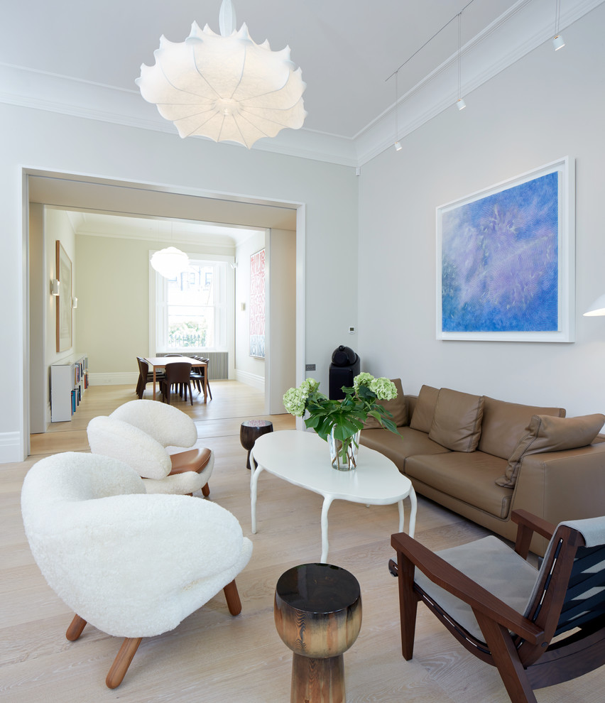 Trendy formal and enclosed light wood floor living room photo in London with gray walls