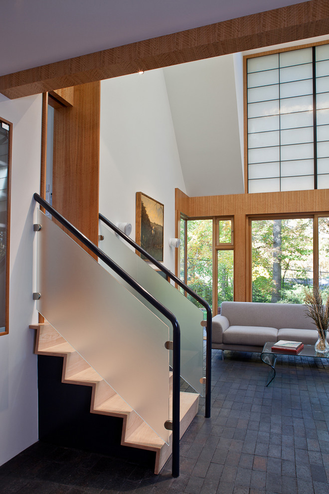 Photo of a modern living room in DC Metro with brick flooring.