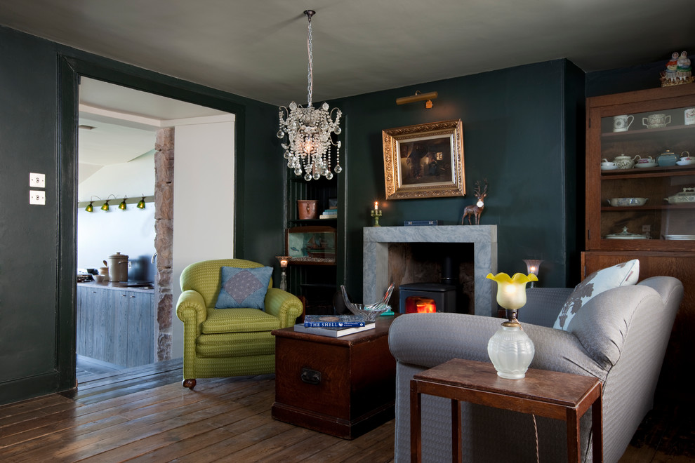 Photo of a medium sized modern living room in Edinburgh with black walls, dark hardwood flooring and no tv.