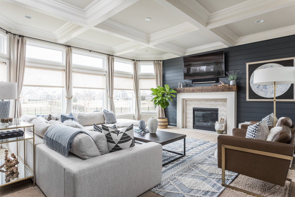Inspiration for a medium sized traditional enclosed living room in Indianapolis with blue walls, carpet, a standard fireplace, a tiled fireplace surround, a wall mounted tv, beige floors and feature lighting.