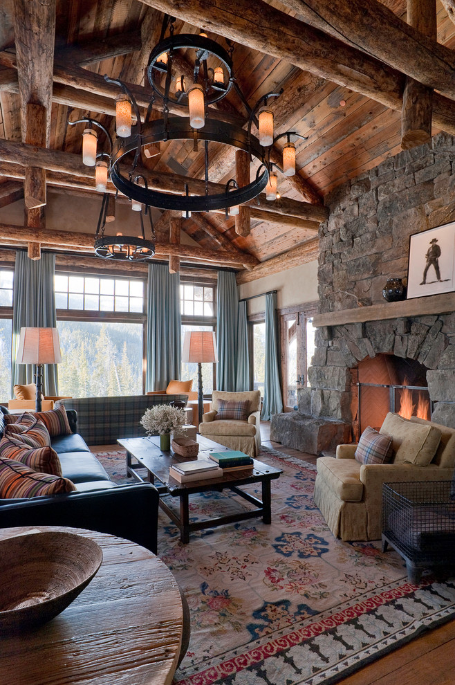 Design ideas for a large rustic living room in Other with a standard fireplace, a stone fireplace surround and no tv.