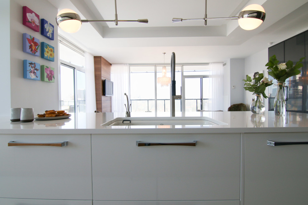 This is an example of a medium sized modern kitchen in Toronto with concrete flooring.