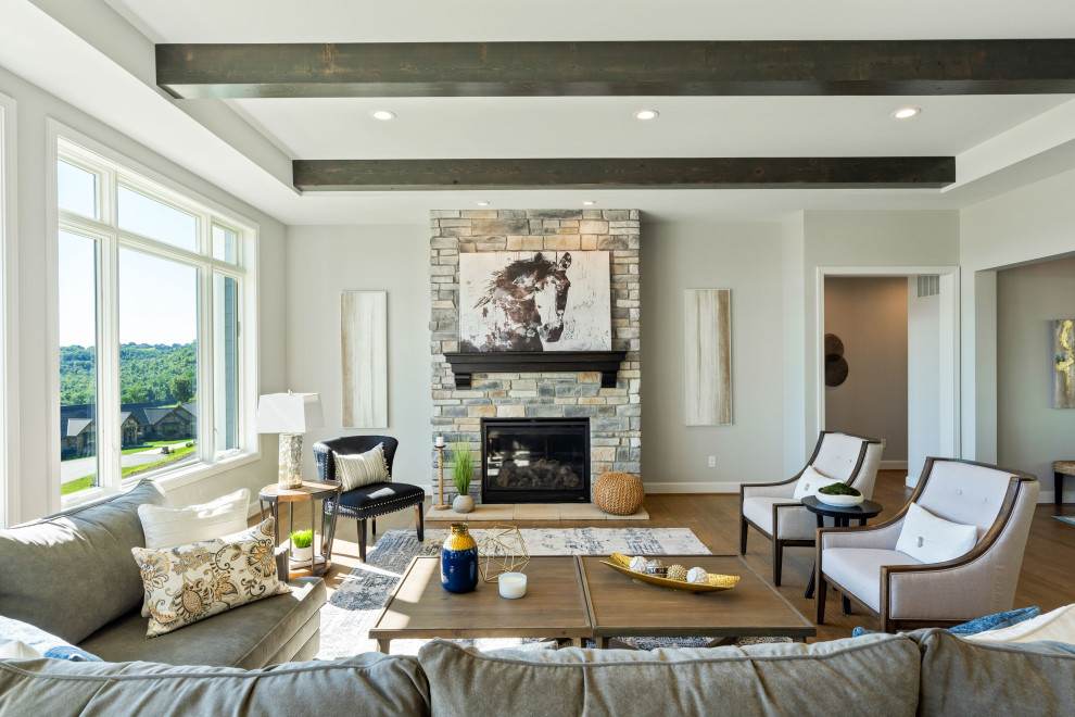 Inspiration for a traditional living room in Cincinnati with grey walls, dark hardwood flooring, a standard fireplace, a stacked stone fireplace surround, brown floors and exposed beams.