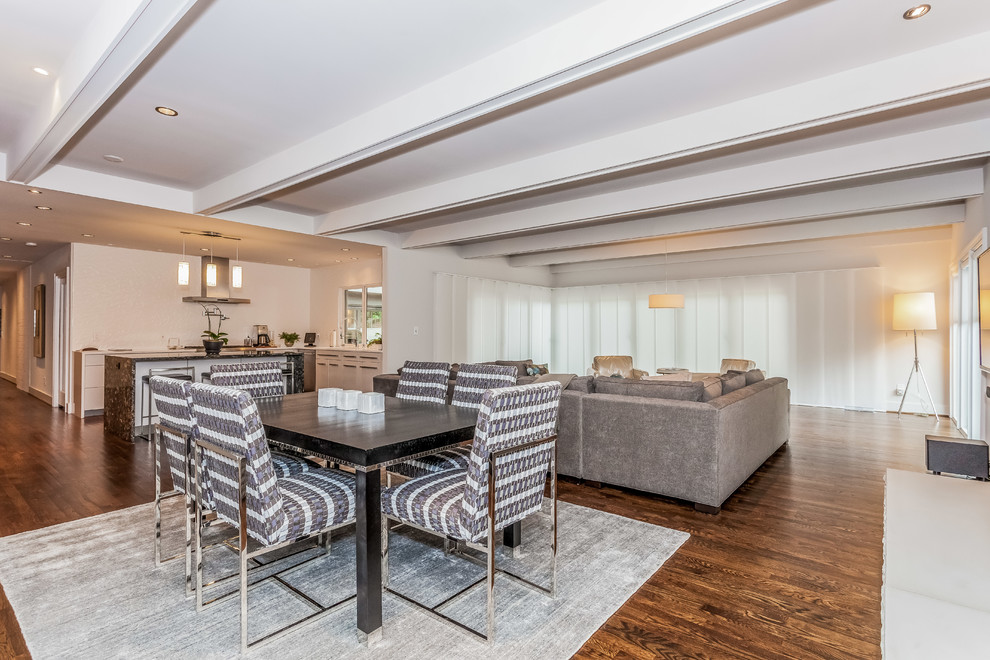 Example of a large trendy open concept medium tone wood floor and brown floor living room design in Atlanta with beige walls