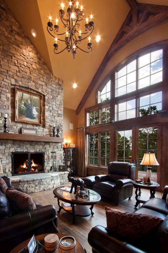 Inspiration for an expansive rustic open plan living room in Other with a reading nook, brown walls, medium hardwood flooring, a standard fireplace, a stone fireplace surround, a built-in media unit and brown floors.