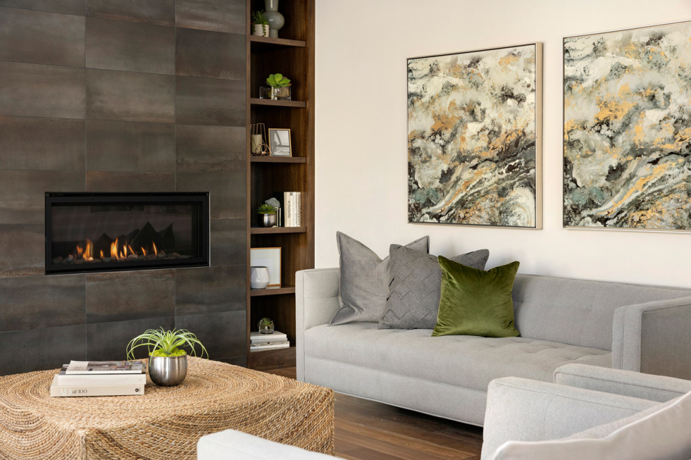 Design ideas for a medium sized contemporary open plan living room feature wall in Minneapolis with grey walls, medium hardwood flooring, a ribbon fireplace, a tiled fireplace surround, a wall mounted tv and brown floors.