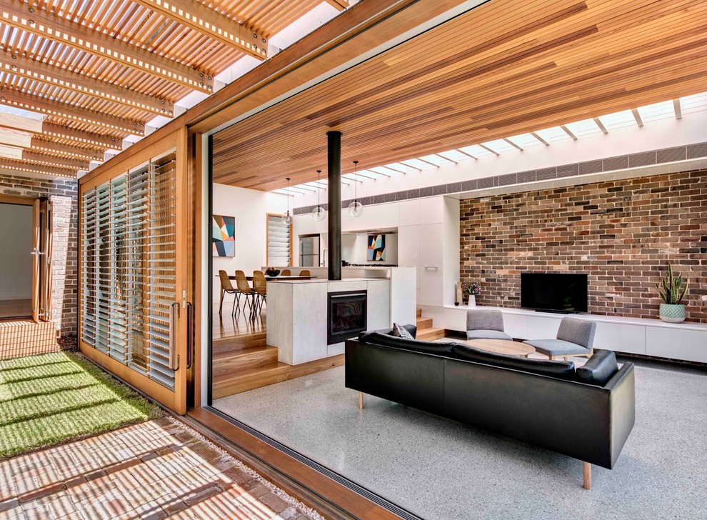 Пример оригинального дизайна: открытая гостиная комната среднего размера в стиле модернизм с бетонным полом, стандартным камином и отдельно стоящим телевизором