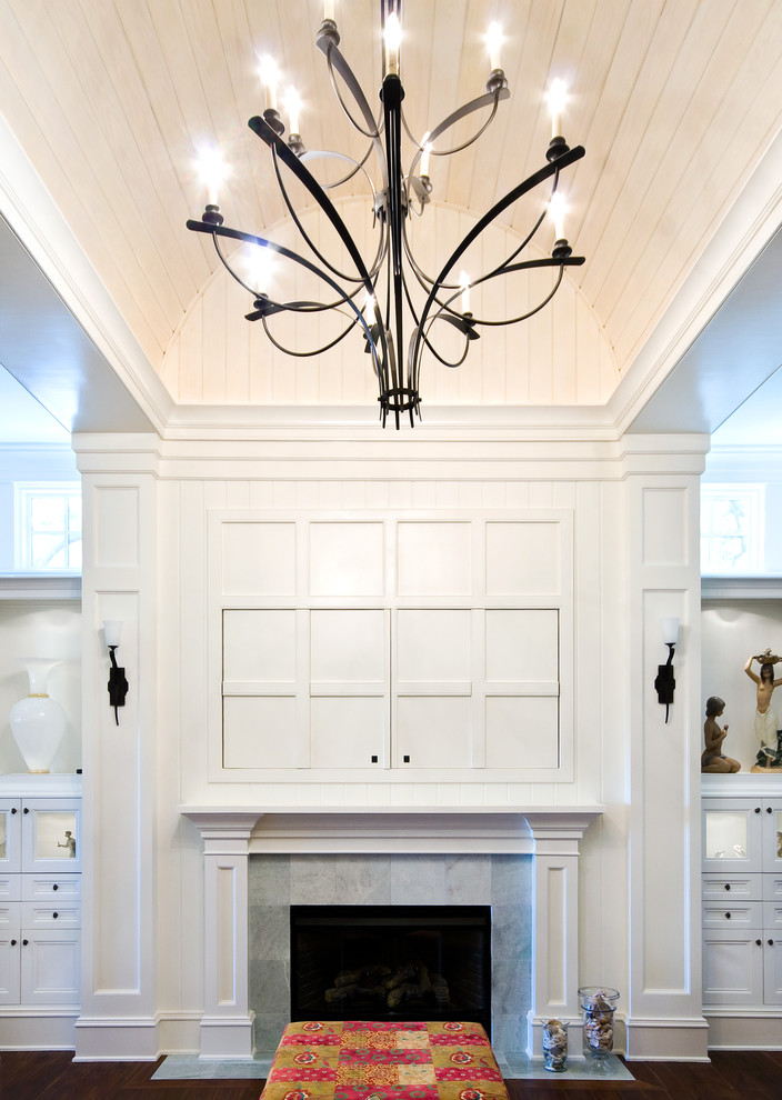 Example of a mid-sized trendy open concept medium tone wood floor living room design in Charleston with white walls, a standard fireplace, a tile fireplace and a concealed tv
