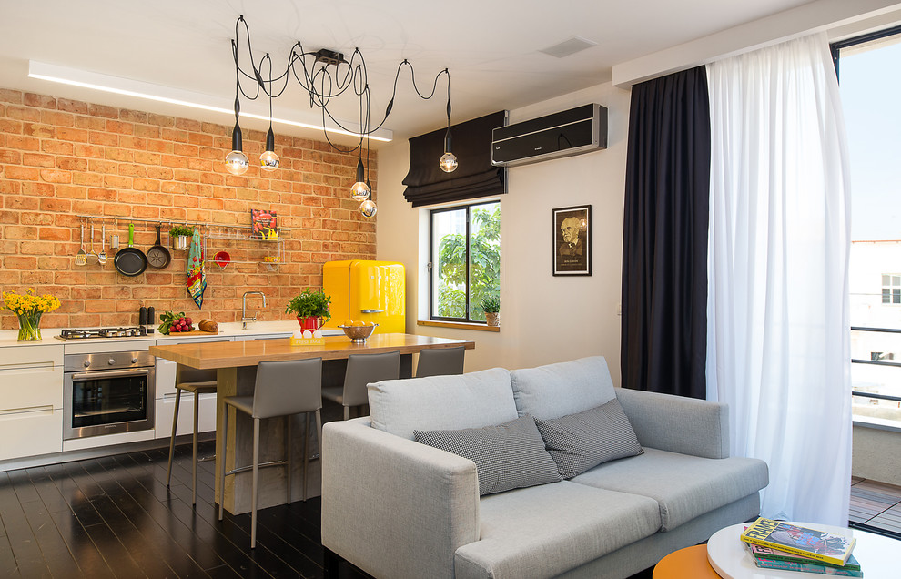 Foto di un piccolo soggiorno minimal stile loft con pareti bianche e pavimento in legno verniciato