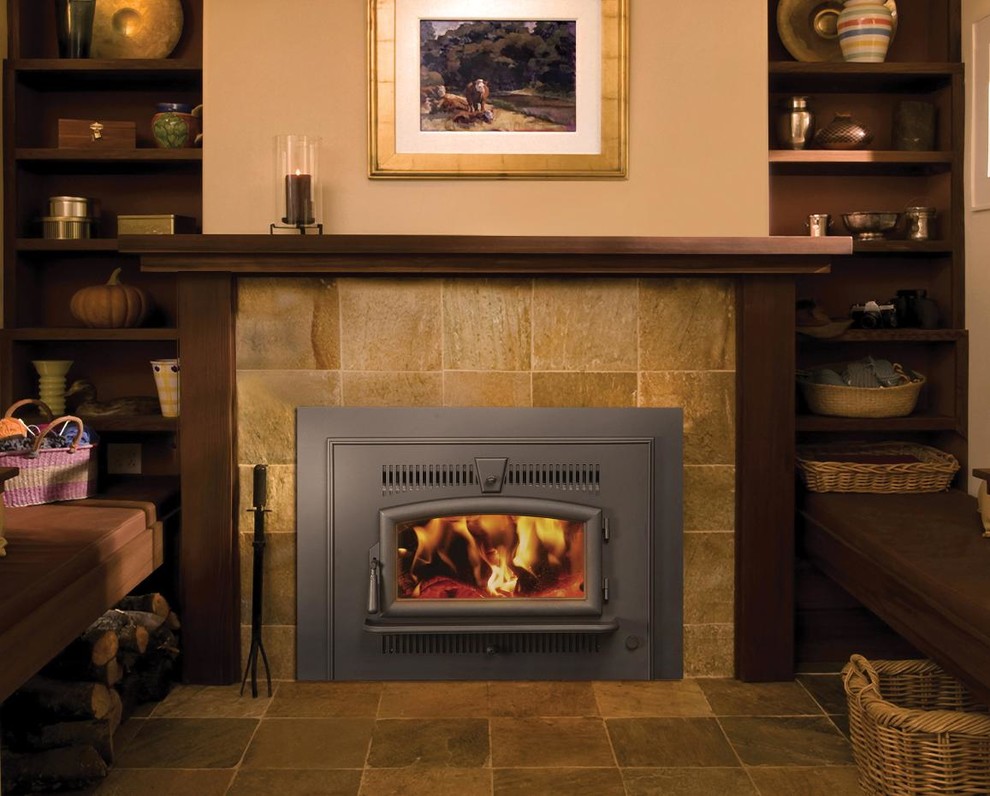 シアトルにある小さなトラディショナルスタイルのおしゃれなリビング (ベージュの壁、スレートの床、標準型暖炉、石材の暖炉まわり、茶色い床) の写真
