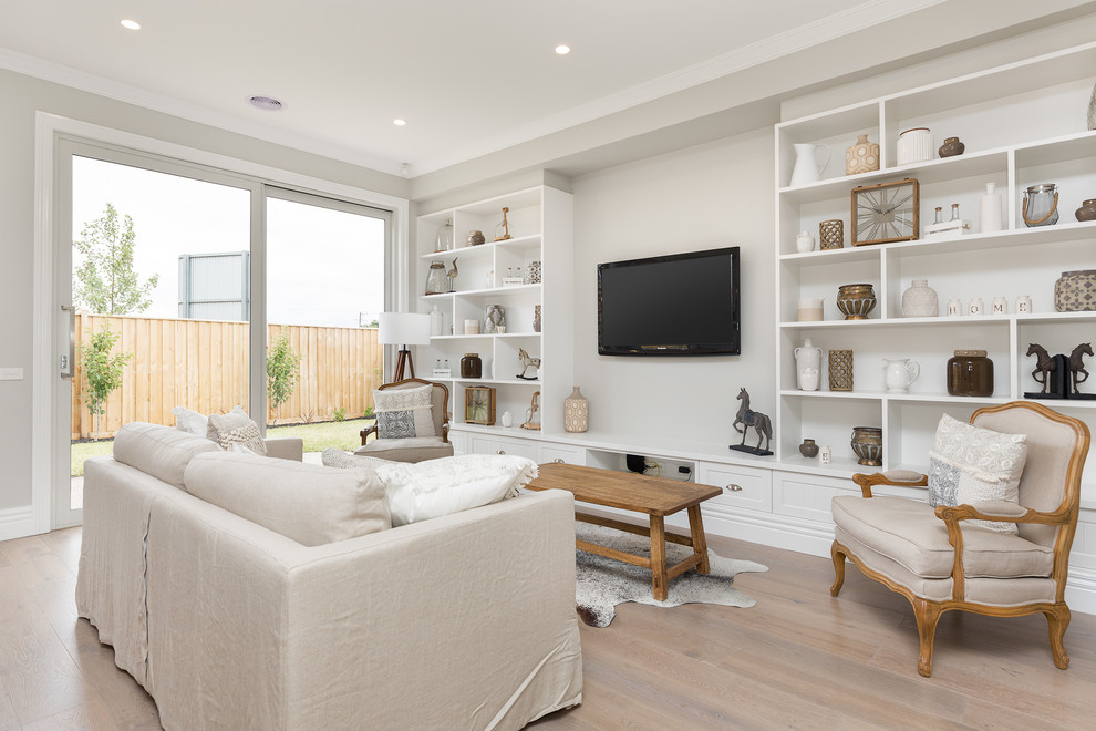 Design ideas for a contemporary formal living room in Melbourne with grey walls, medium hardwood flooring and a wall mounted tv.