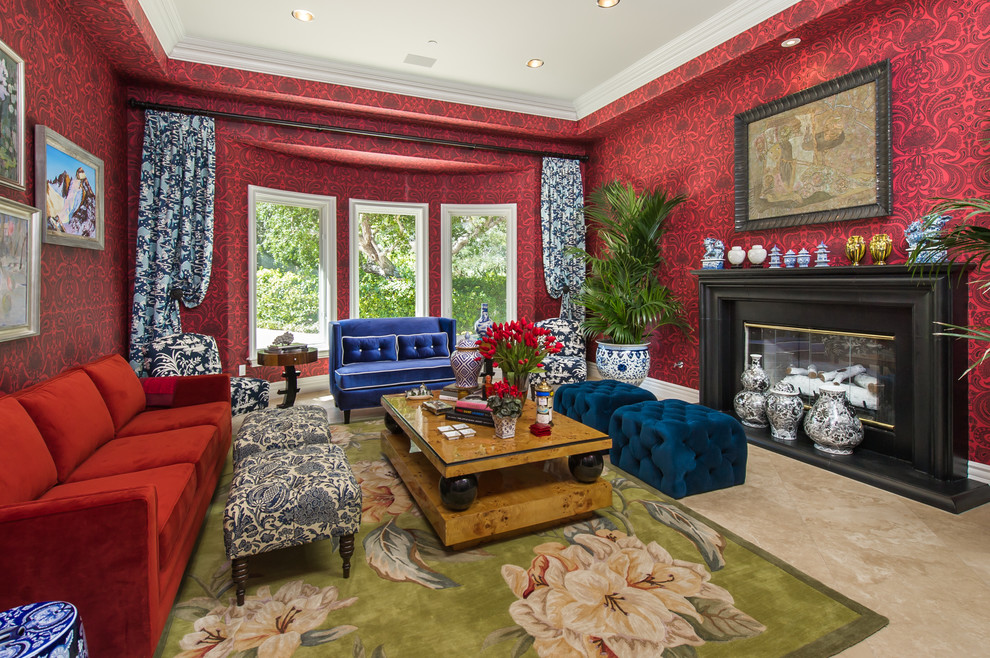 На фото: парадная гостиная комната в средиземноморском стиле с красными стенами, стандартным камином, бежевым полом и эркером с