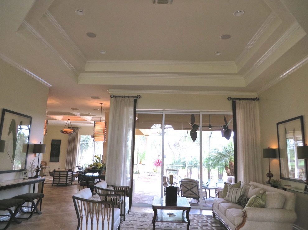 Immagine di un soggiorno tropicale di medie dimensioni e aperto con sala formale, nessuna TV, pareti beige e pavimento beige