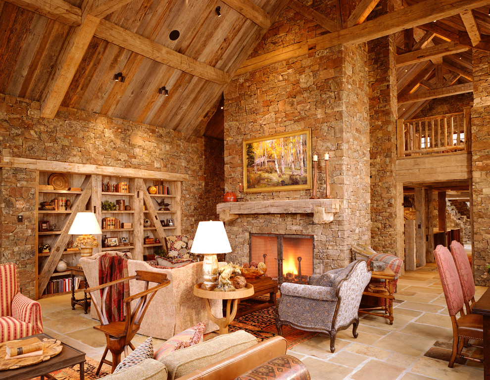 Imagen de salón abierto rural con paredes beige, todas las chimeneas y marco de chimenea de piedra