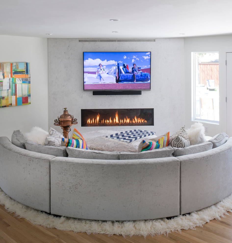 Example of a small trendy open concept light wood floor and beige floor living room design in Dallas with white walls, a ribbon fireplace, a stone fireplace and a wall-mounted tv