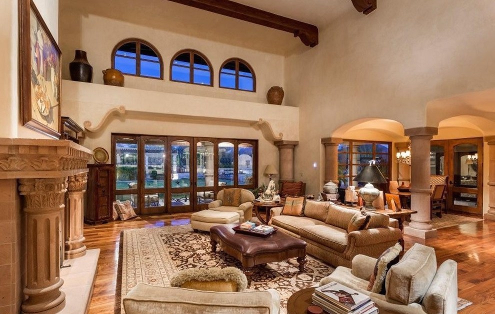 Example of a huge classic formal and open concept travertine floor living room design in Phoenix with beige walls, a standard fireplace, a stone fireplace and no tv