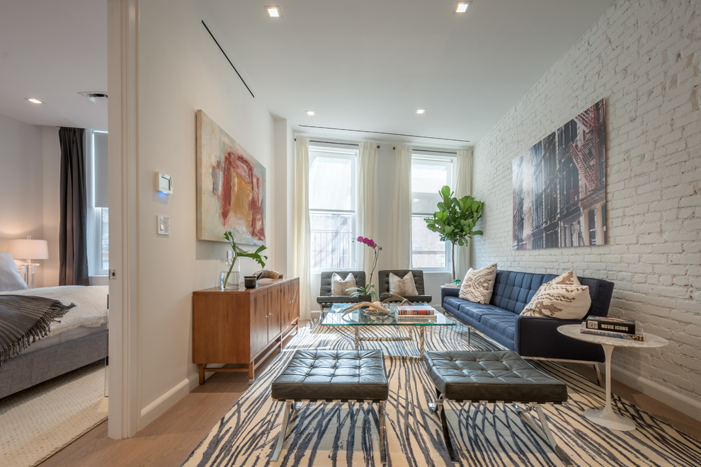 Fernseherloses, Offenes, Mittelgroßes Modernes Wohnzimmer mit weißer Wandfarbe und hellem Holzboden in New York