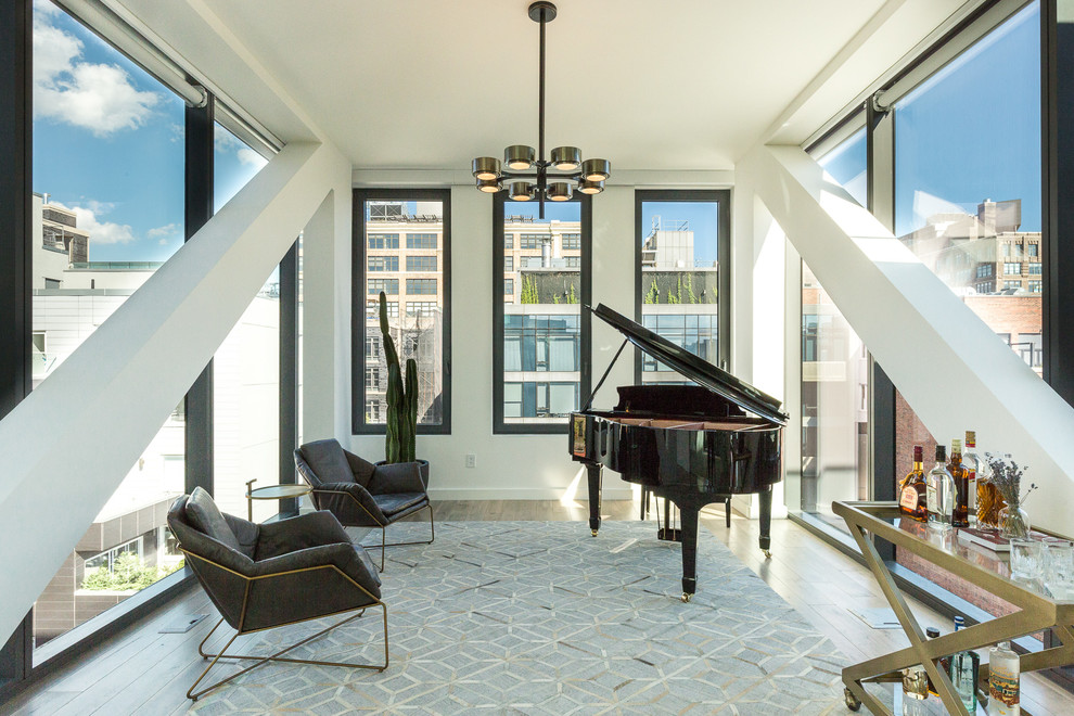 Living room - mid-sized contemporary enclosed medium tone wood floor living room idea in New York with a music area, no tv and white walls
